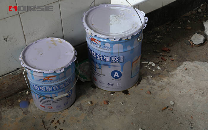 Sistem perbaikan beton bungkus serat karbon